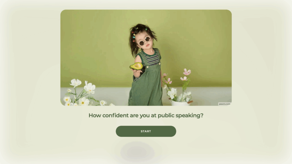 A young girl in green overalls wearing sunglasses and lots of hairclips, is standing in front of a green wall, holding an open avocado in her right hand. There are white and pale pink flowers either side of her. Underneath the picture the title reads "How confident are you at pubilsh speaking?" with a "Start" button.